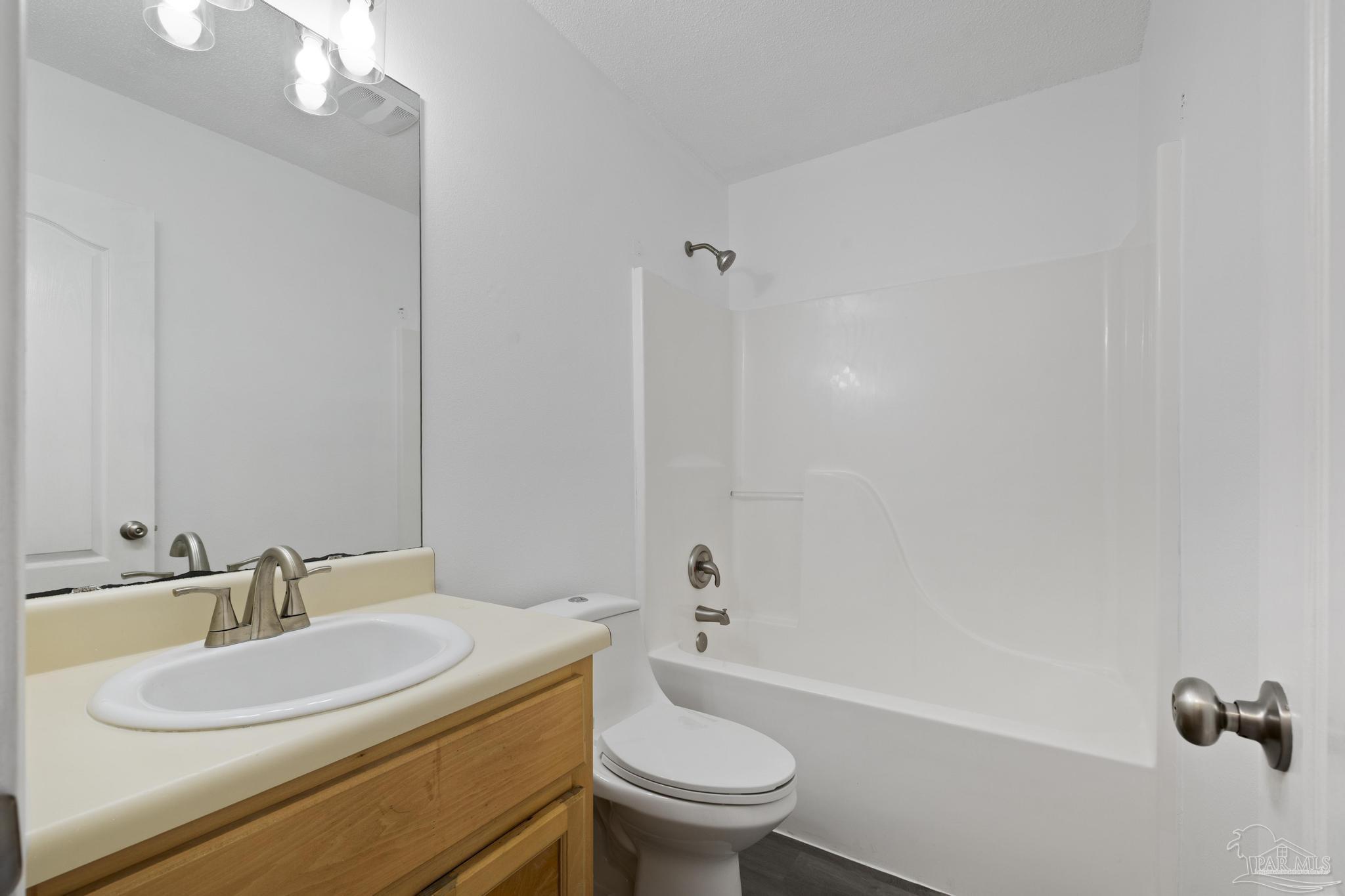 5564 Paddle Wheel Drive Milton, FL 32583 - Photo 20 of 41 a bathroom with a sink a toilet and a mirror