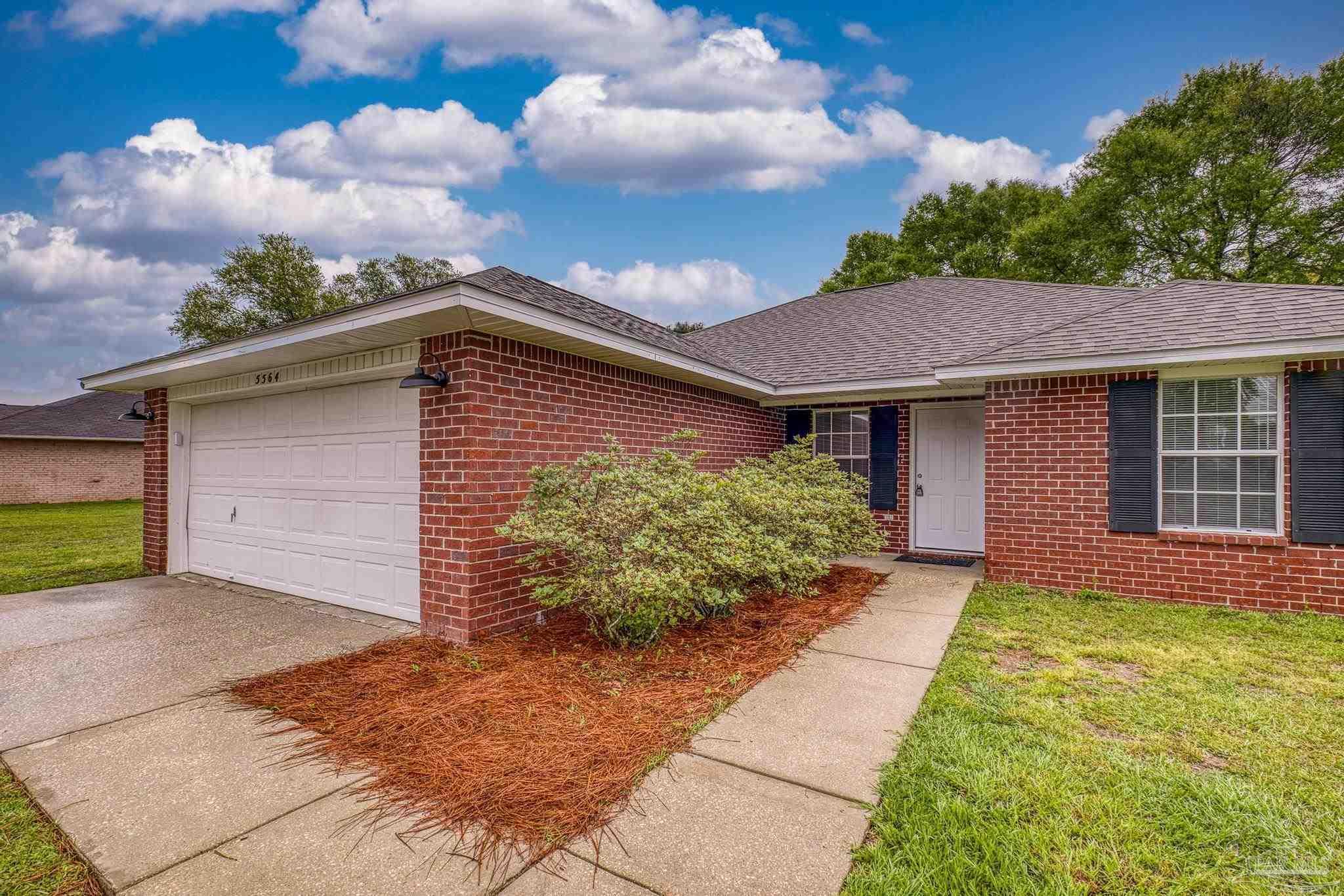 5564 Paddle Wheel Drive Milton, FL 32583 - Photo 2 of 41 a front view of a house with garden