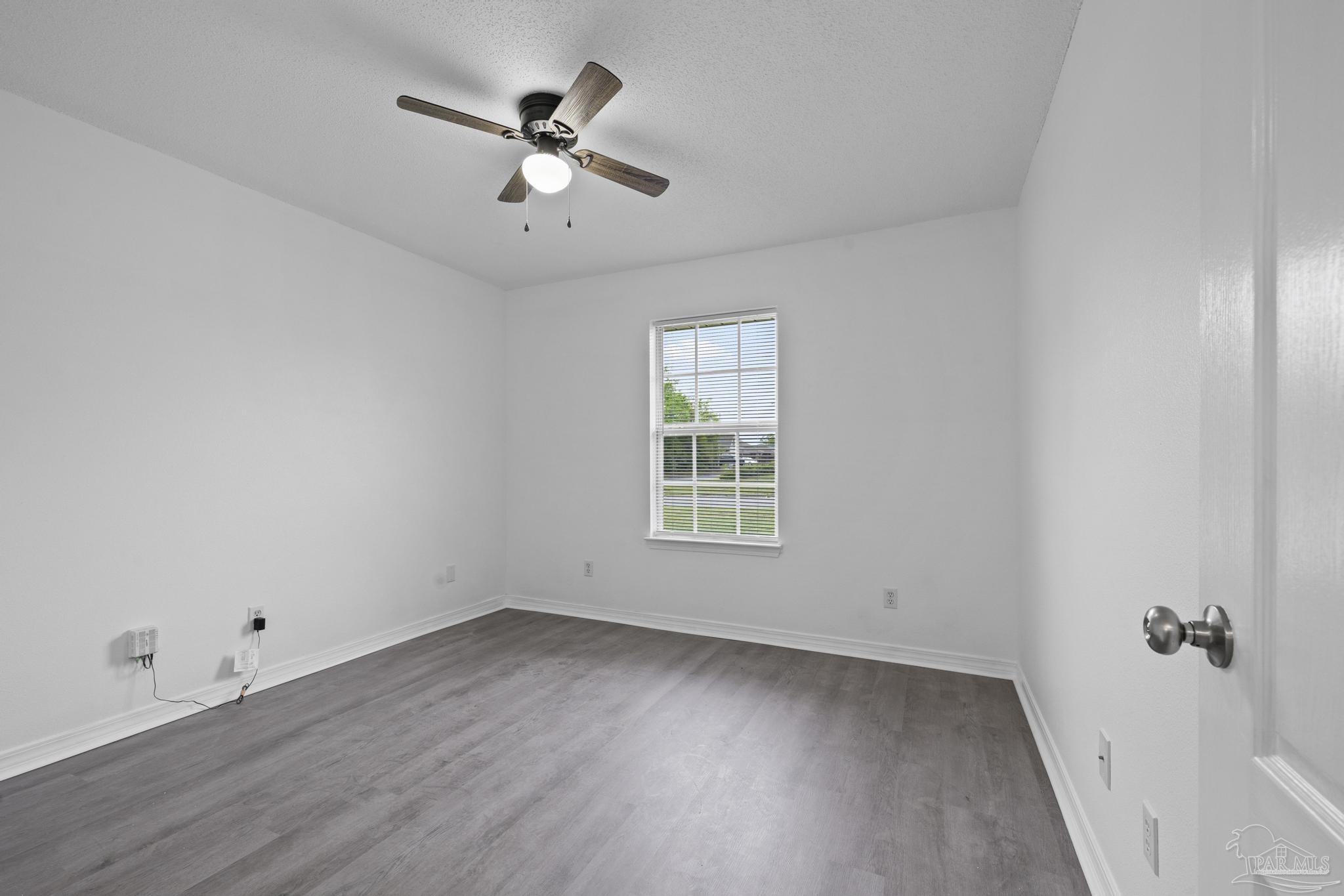 5564 Paddle Wheel Drive Milton, FL 32583 - Photo 21 of 41 wooden floor in an empty room with a window
