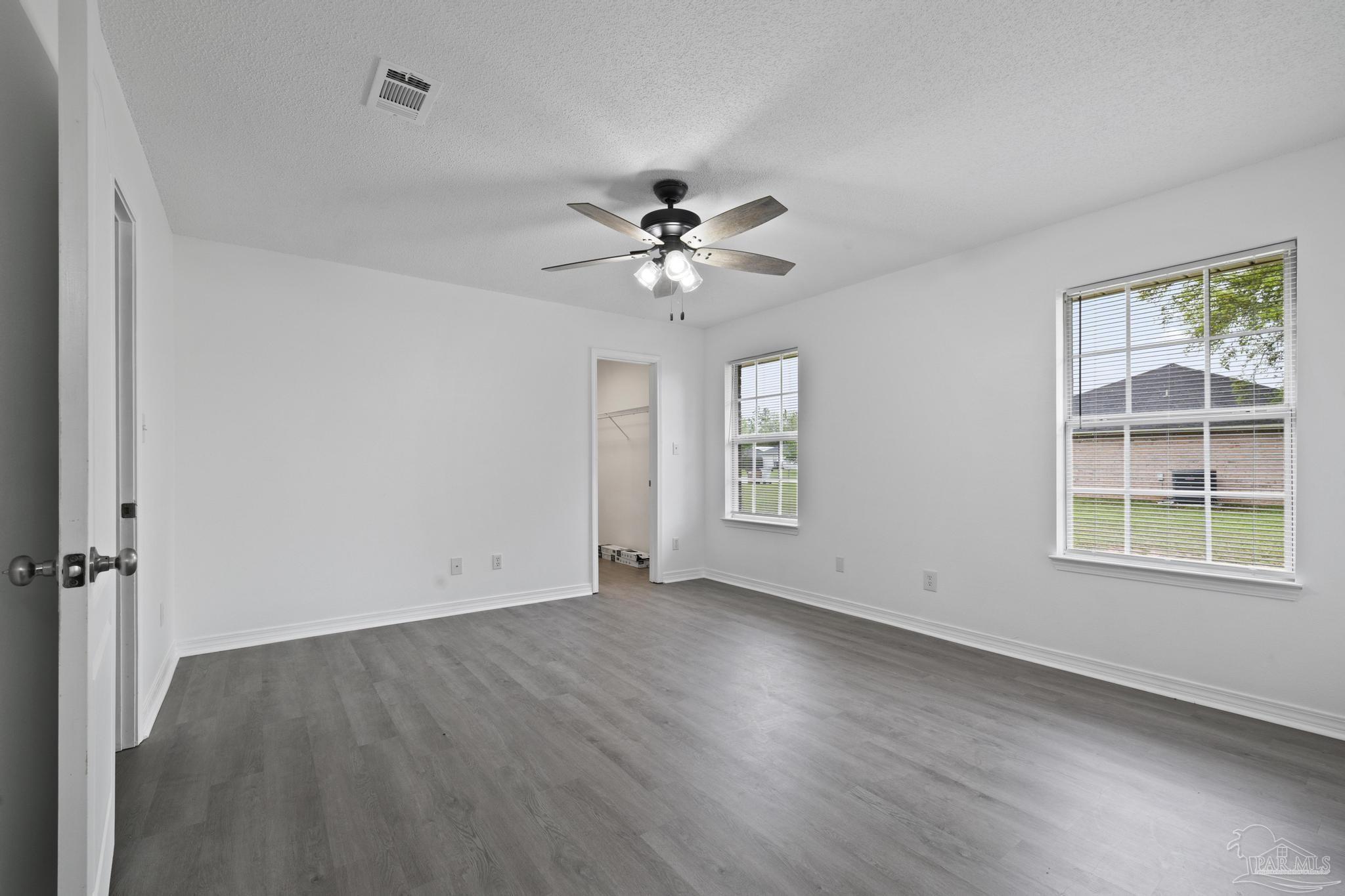 5564 Paddle Wheel Drive Milton, FL 32583 - Photo 24 of 41 wooden floor in an empty room with a window