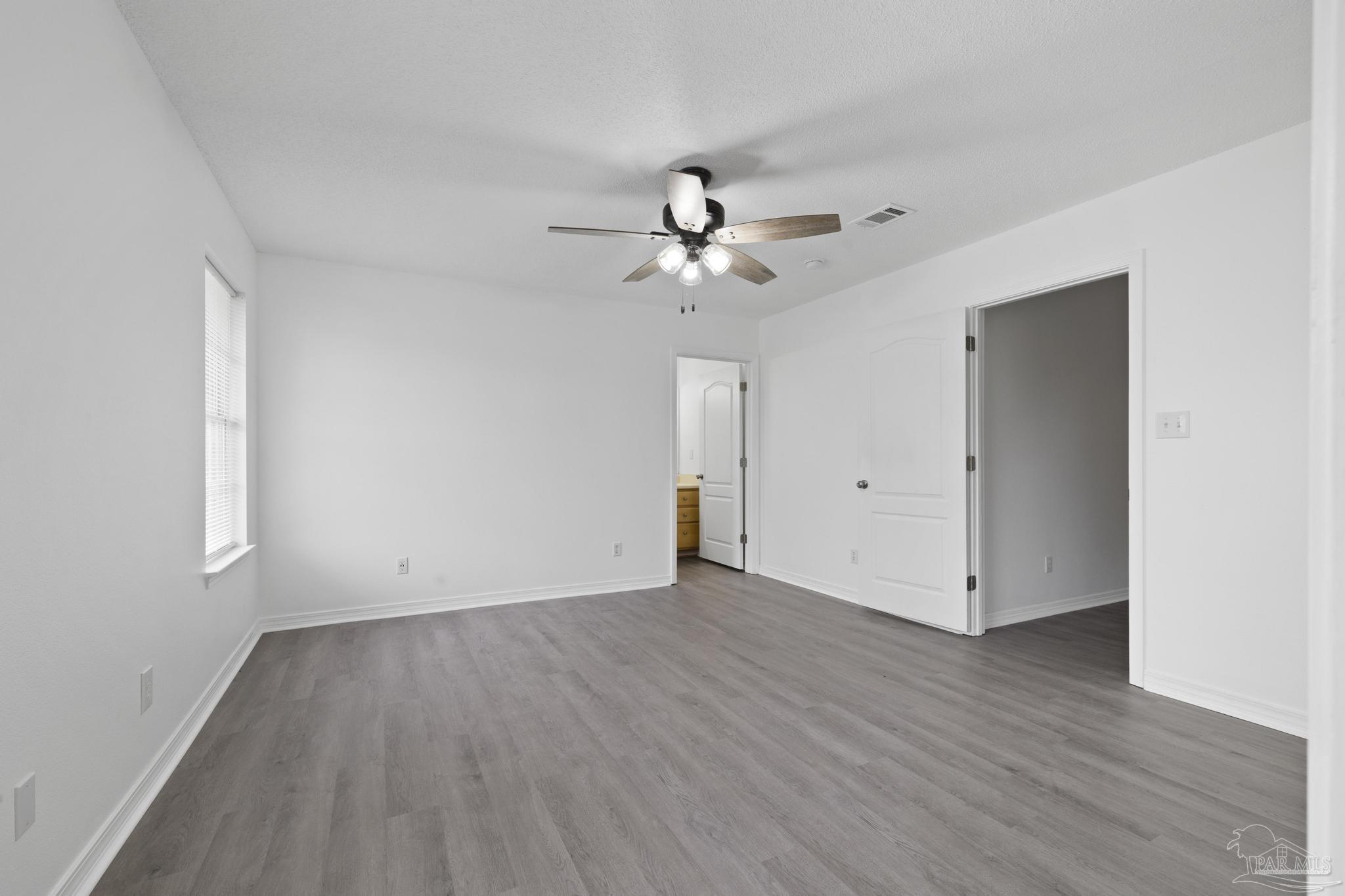 5564 Paddle Wheel Drive Milton, FL 32583 - Photo 25 of 41 a view of an empty room with wooden floor