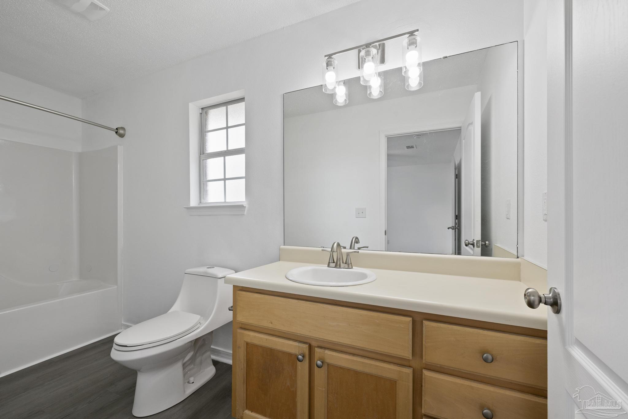 5564 Paddle Wheel Drive Milton, FL 32583 - Photo 26 of 41 a bathroom with a sink a toilet and mirror