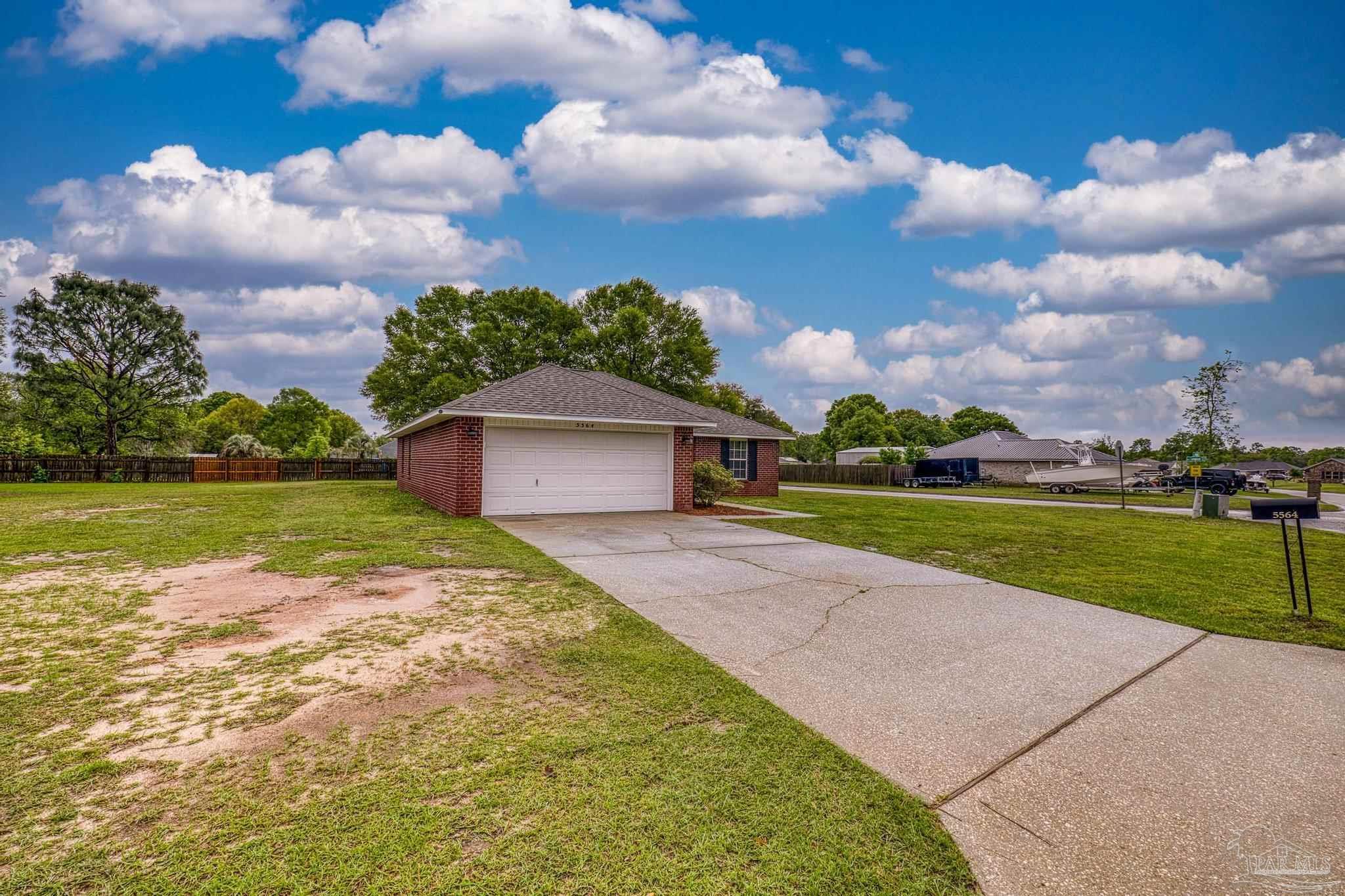 5564 Paddle Wheel Drive Milton, FL 32583 - Photo 4 of 41 a view of a house with a big yard and potted plants