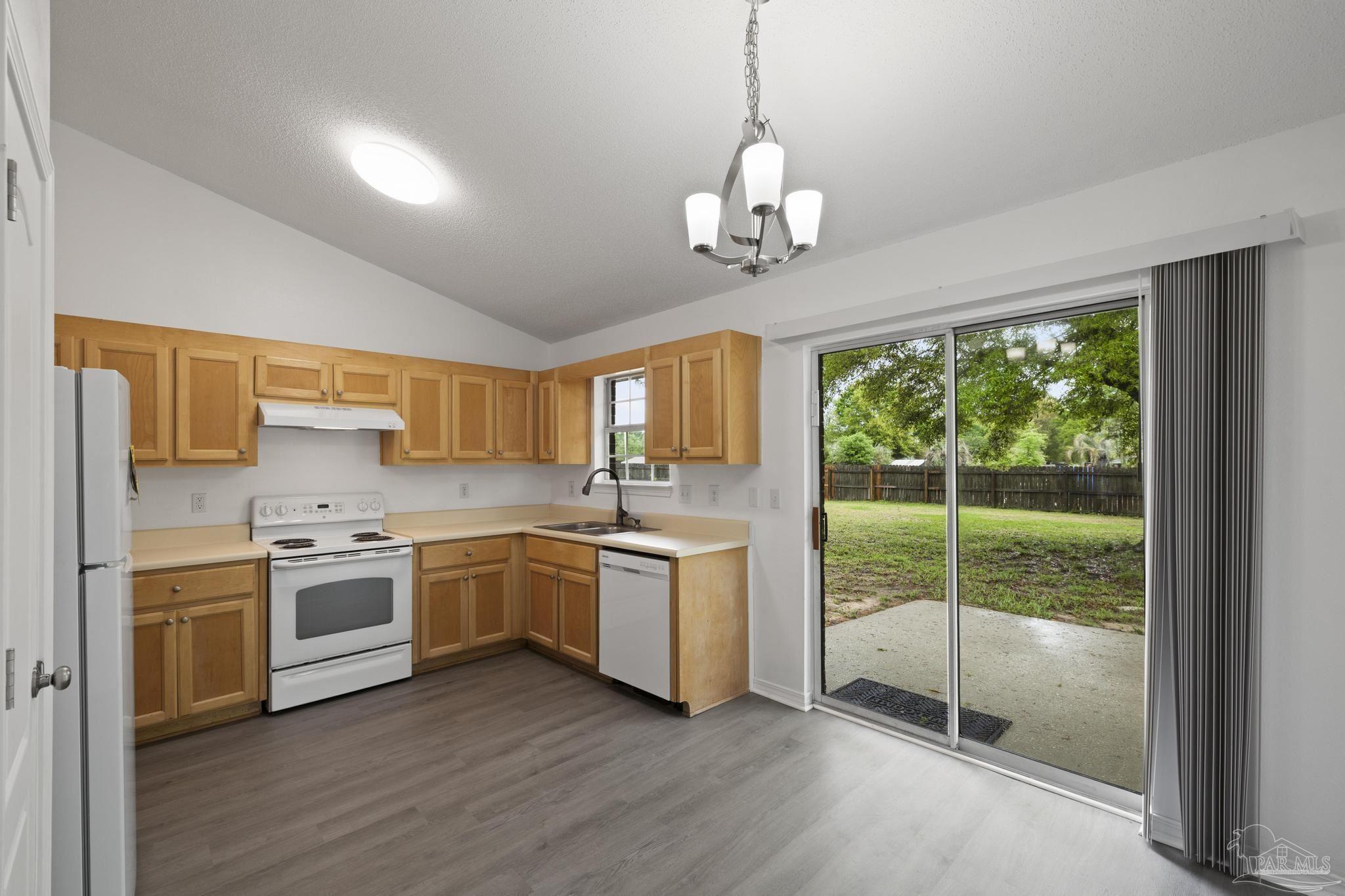 5564 Paddle Wheel Drive Milton, FL 32583 - Photo 5 of 41 a open kitchen with stainless steel appliances granite countertop a stove a sink dishwasher a refrigerator white cabinets and wooden floor