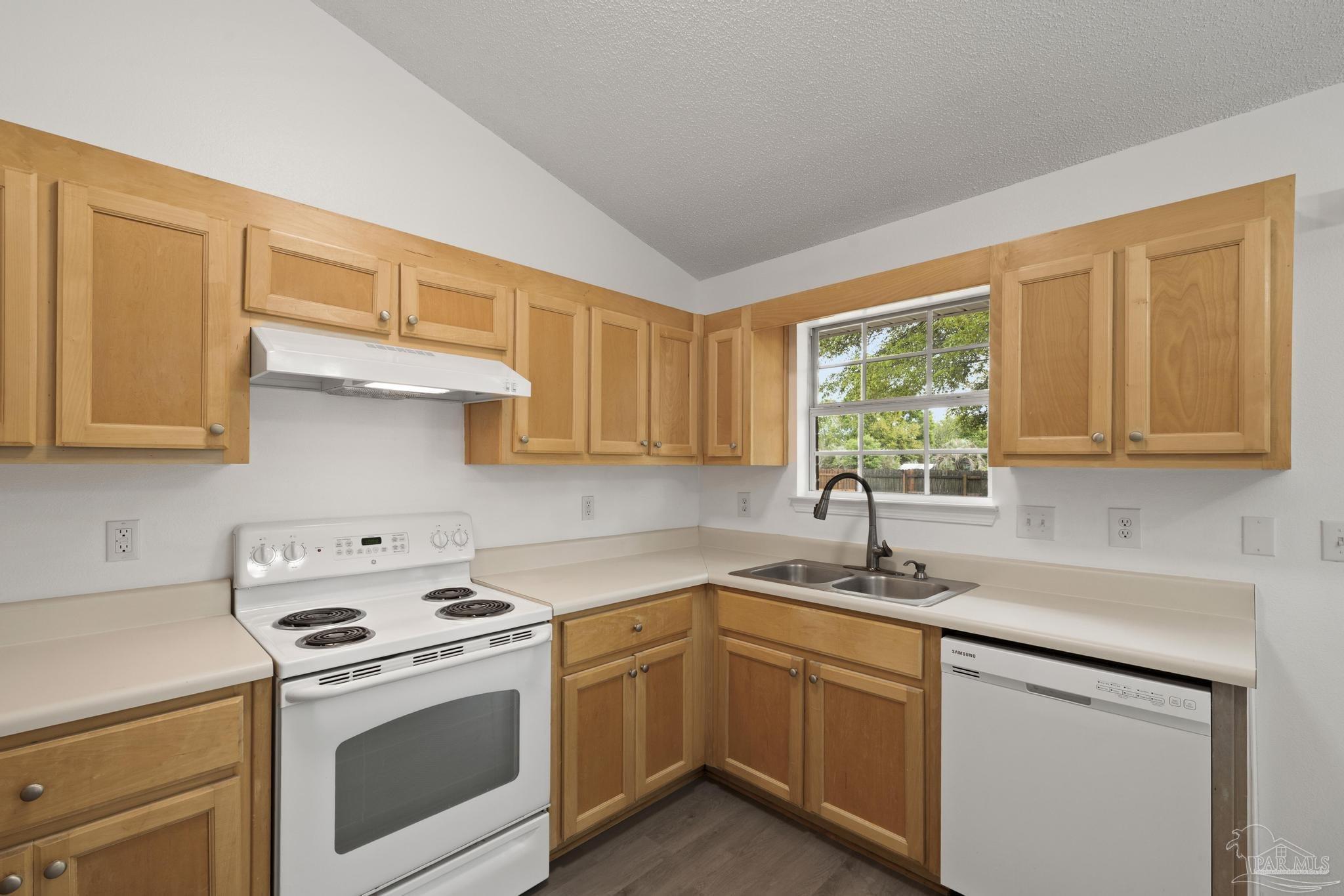 5564 Paddle Wheel Drive Milton, FL 32583 - Photo 8 of 41 a kitchen with stainless steel appliances granite countertop white cabinets a sink and a stove