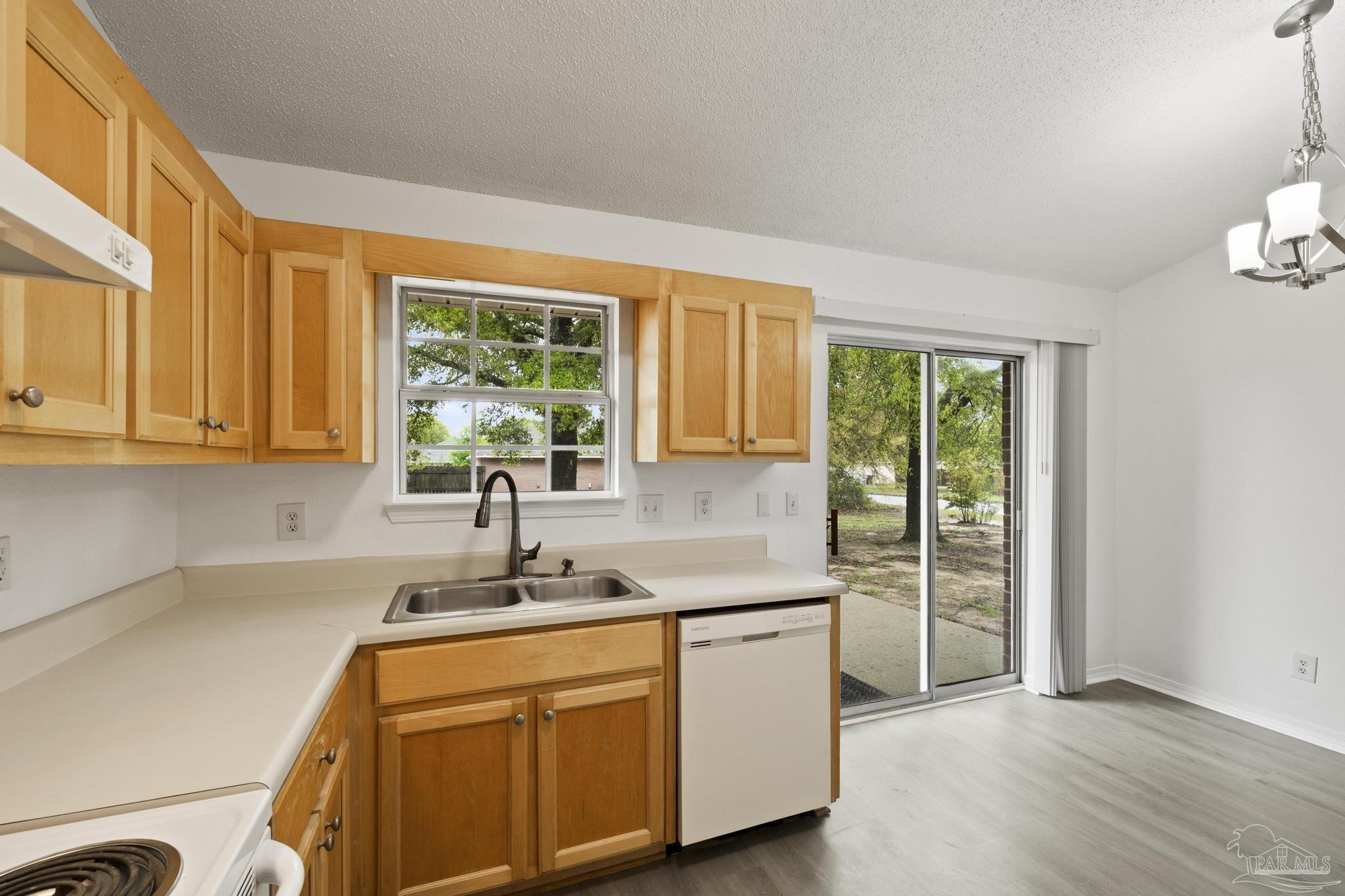 5564 Paddle Wheel Drive Milton, FL 32583 - Photo 9 of 41 a kitchen with stainless steel appliances granite countertop a sink a window and a counter space