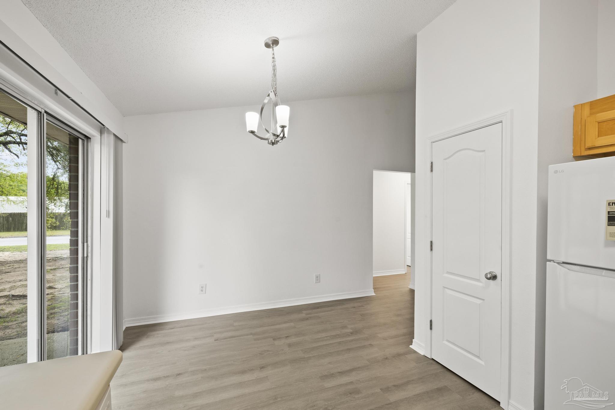 5564 Paddle Wheel Drive Milton, FL 32583 - Photo 10 of 41 a view of empty room with wooden floor and fan