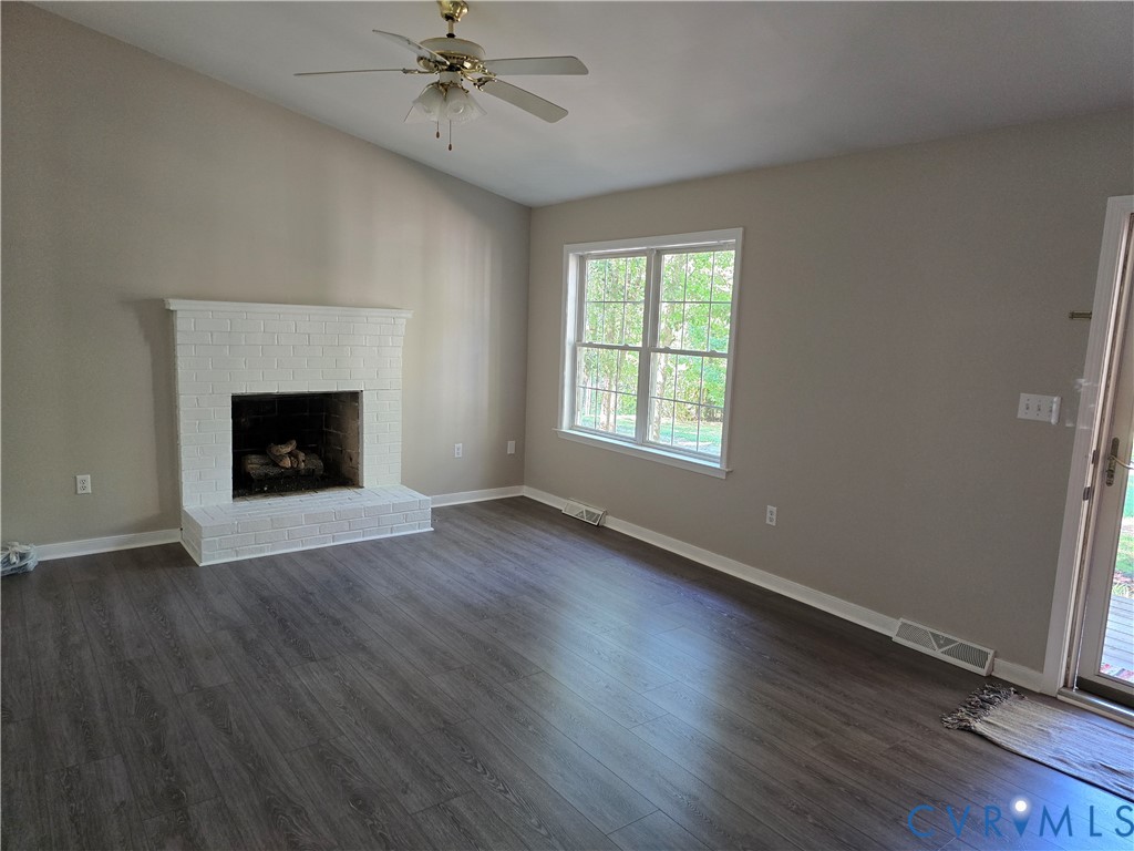 2578 Bagby Road Bumpass, VA 23024 - Photo 5 of 26 Vaulted ceiling with a ceiling fan, white brick fi