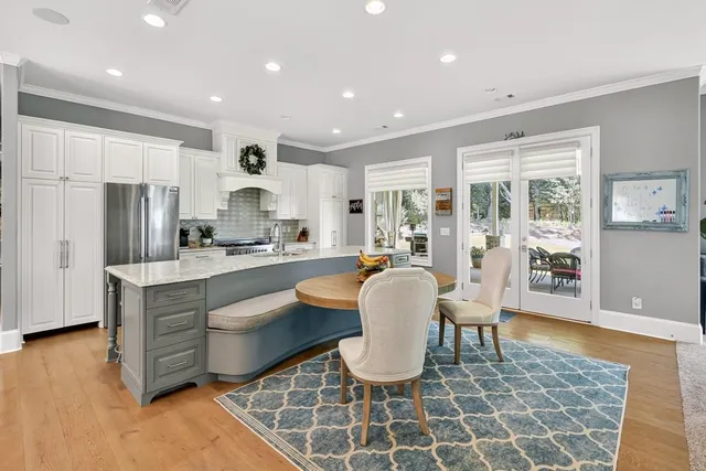 a bathroom with a granite countertop sink mirror vanity and toilet