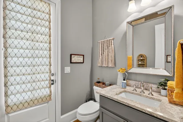 a living room with furniture a flat screen tv and a floor to ceiling window