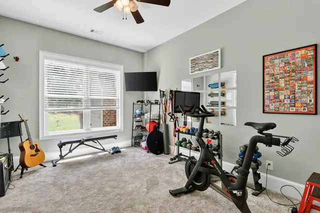 a view of a hallway with wooden floor and furniture