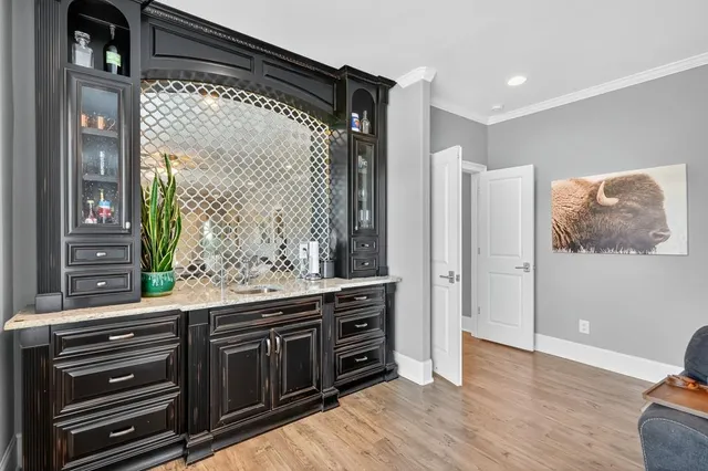 a spacious bedroom with a bed and a chandelier