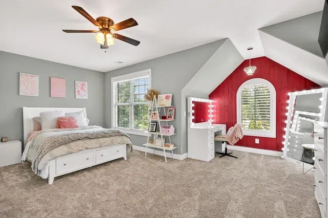 a bedroom with a bed and a bookshelf