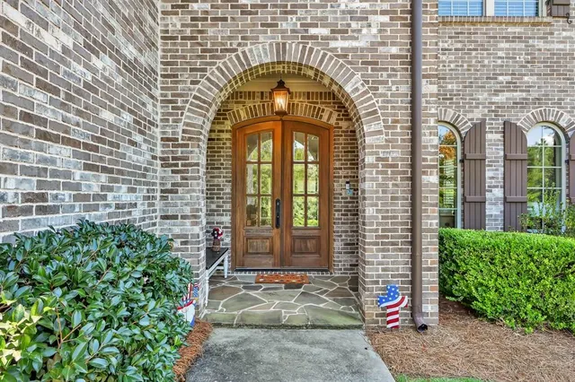 a view of a workspace with furniture and a bookshelf