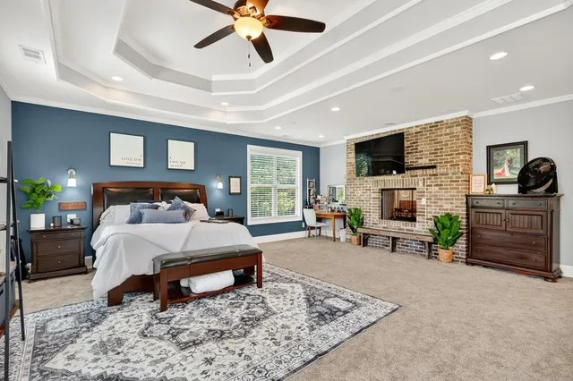 a aerial view of a house with a yard and lake