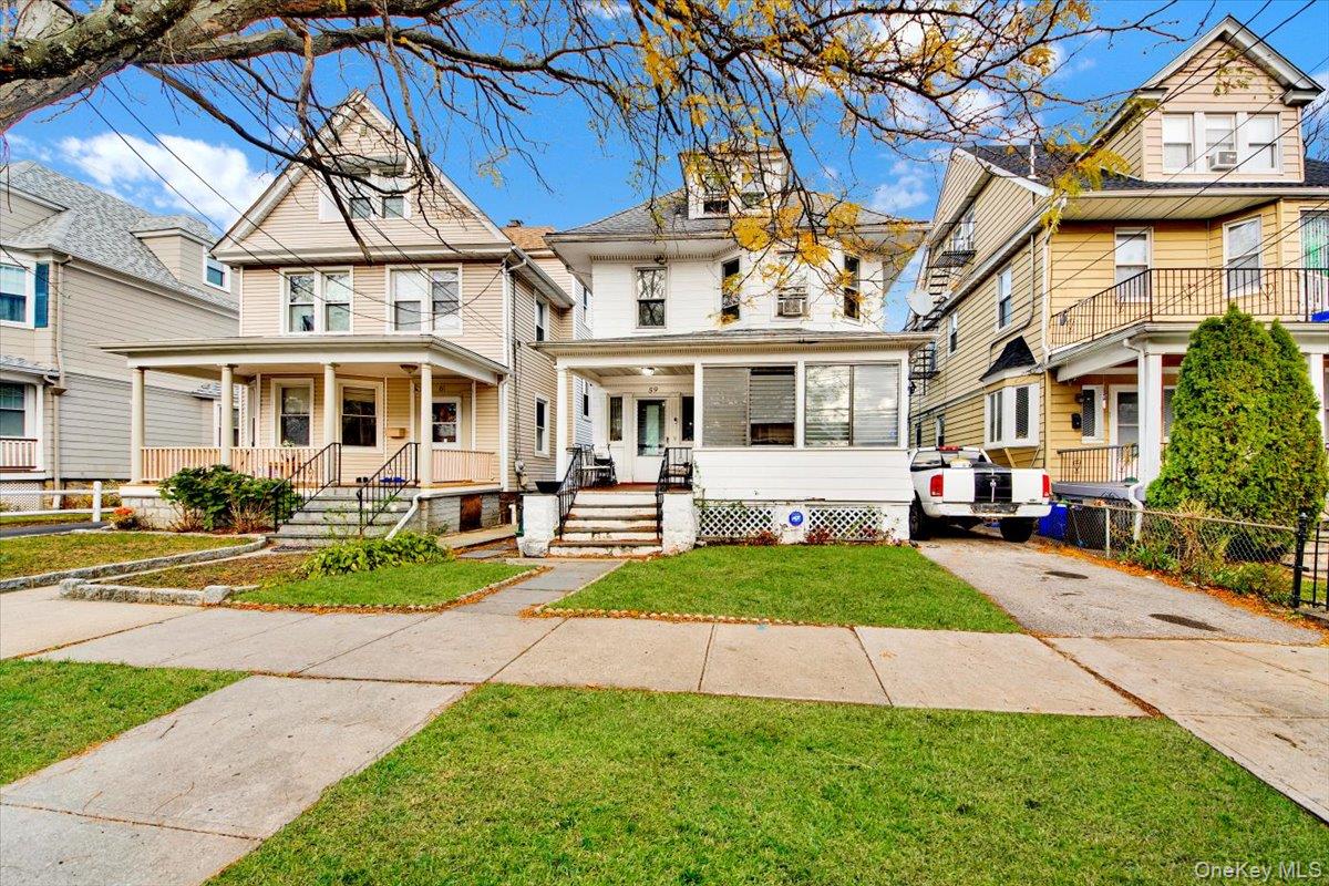 a view of a yard in front of a brick house