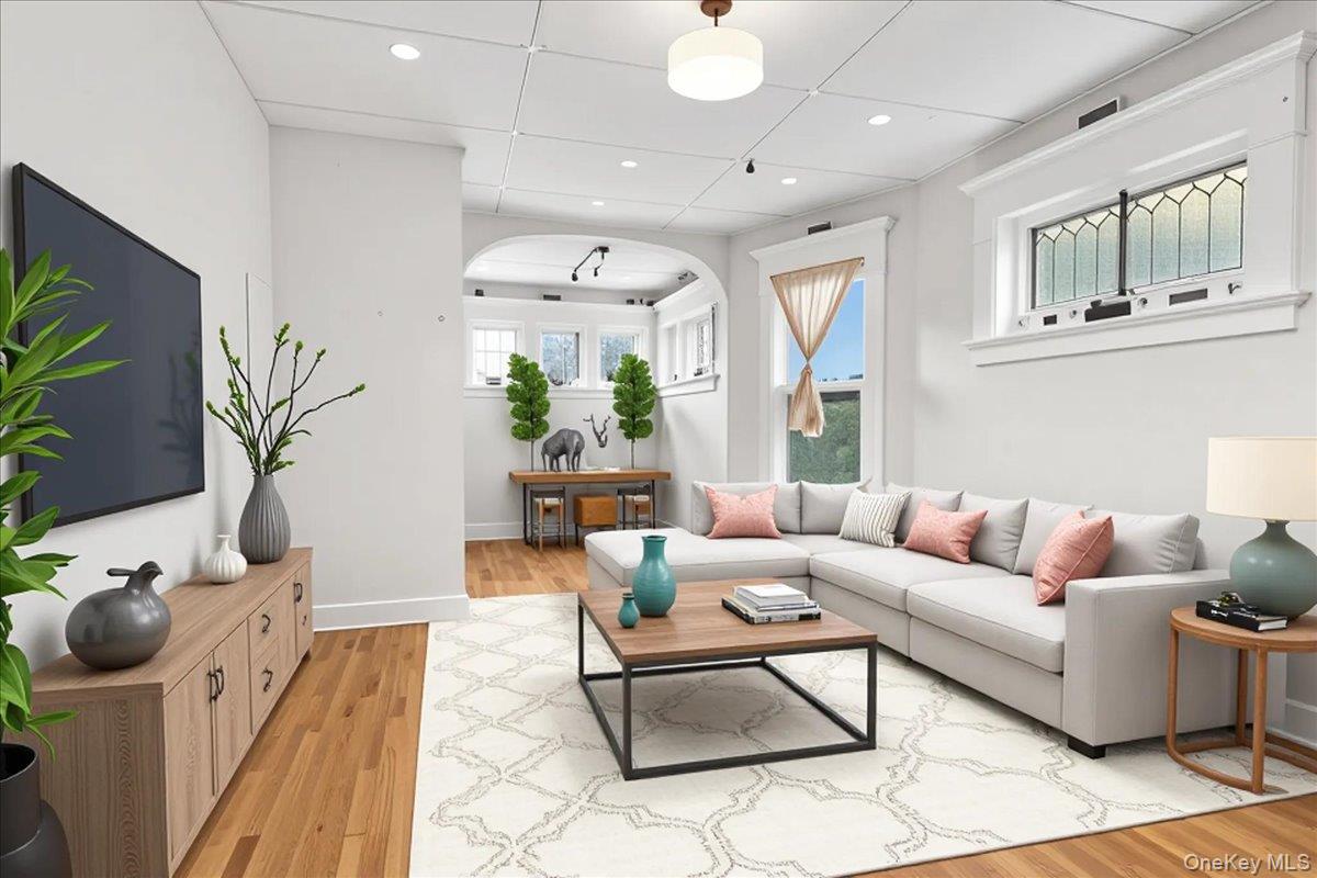 59 Jackson Street New Rochelle, NY 10801 - Photo 11 of 15 a living room with furniture potted plant and a large window