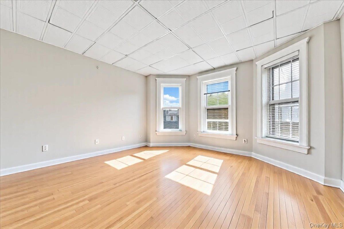 59 Jackson Street New Rochelle, NY 10801 - Photo 13 of 15 a view of an empty room with wooden floor and a window