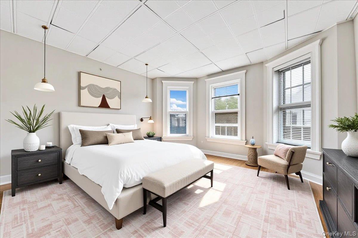 59 Jackson Street New Rochelle, NY 10801 - Photo 14 of 15 a spacious bedroom with a bed a couch and large window