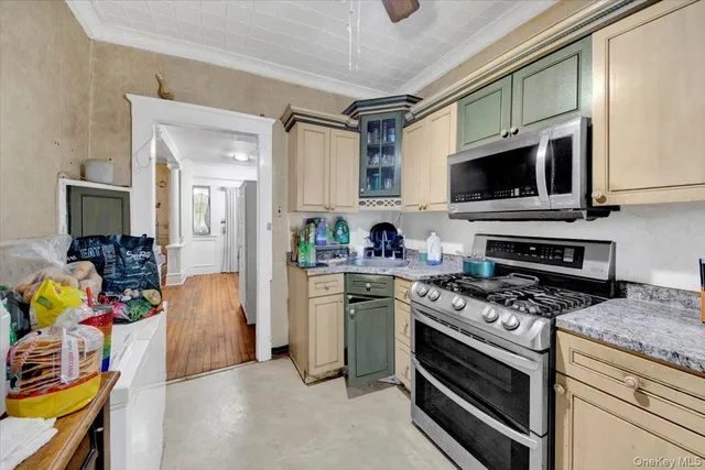 a kitchen with stainless steel appliances a stove sink and microwave