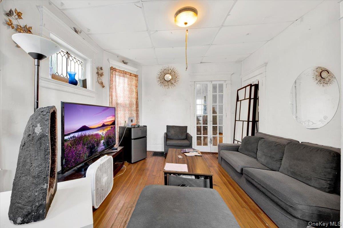59 Jackson Street New Rochelle, NY 10801 - Photo 9 of 15 a living room with furniture a flat screen tv and a fireplace