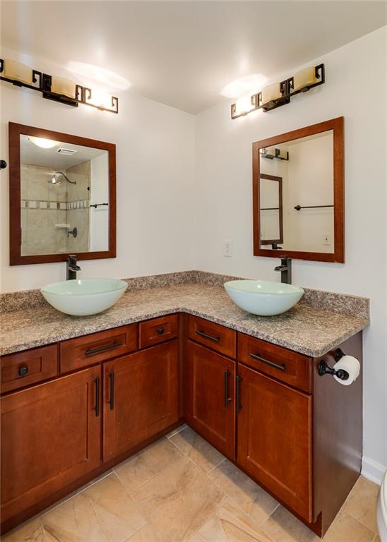 Undisclosed Address Atlanta, GA 30326 - Photo 16 of 38 a bathroom with a granite countertop sink and a mirror