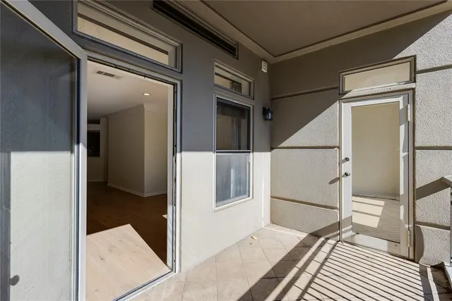 a view of balcony with a large window and wooden floor