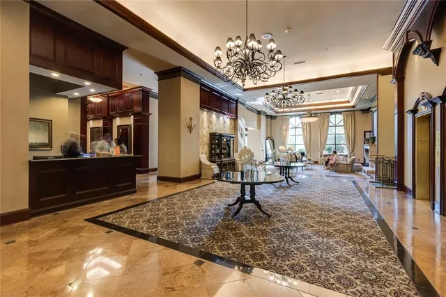 a living room with furniture a fireplace and large windows