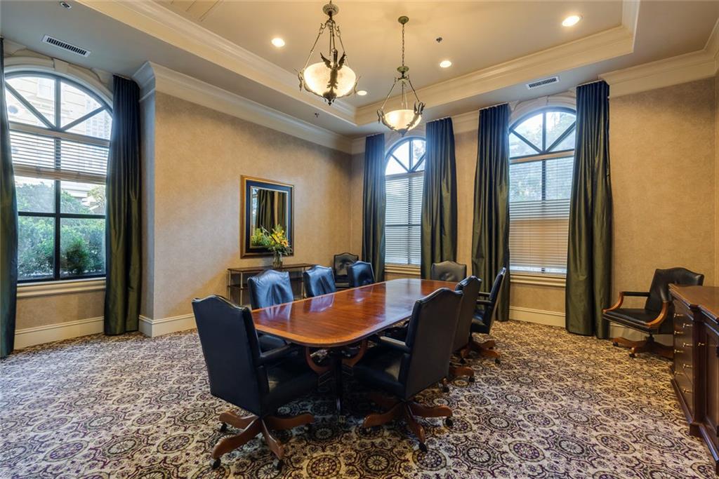 Undisclosed Address Atlanta, GA 30326 - Photo 27 of 38 a dining room with wooden floor a chandelier a wooden table and chairs