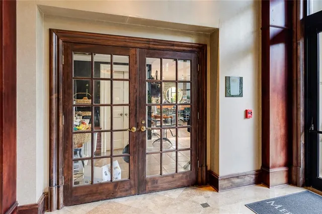 a living room with furniture flat screen tv and floor to ceiling window