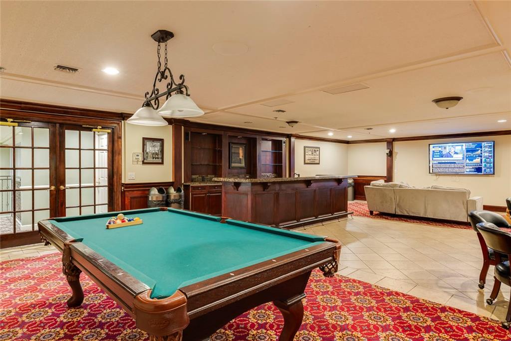 Undisclosed Address Atlanta, GA 30326 - Photo 30 of 38 a room with pool table windows and a flat screen tv