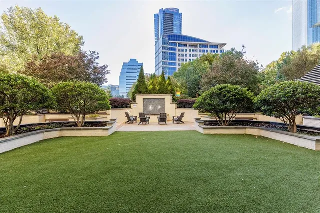 a view of a swimming pool with outdoor seating and plants