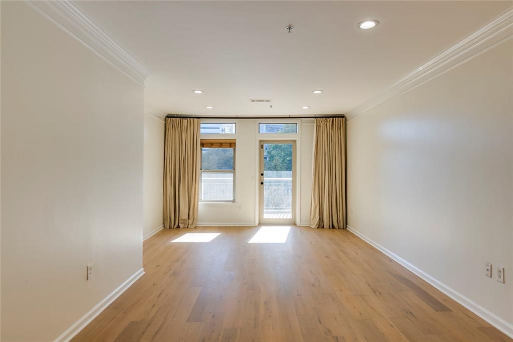 Undisclosed Address Atlanta, GA 30326 - Photo 6 of 38 an empty room with wooden floor and windows