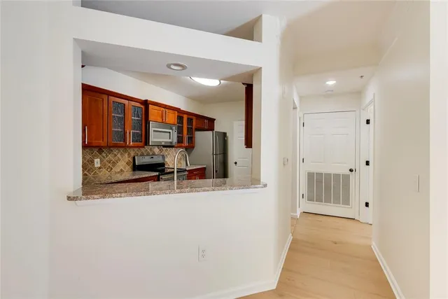 a view of a bathroom with mirror and window