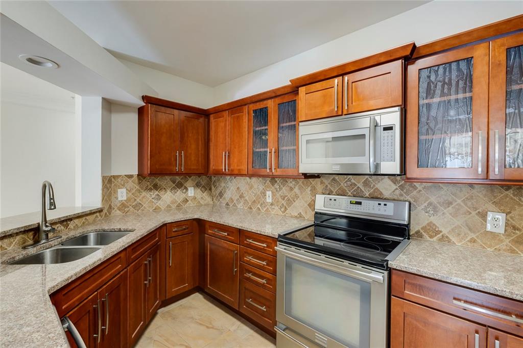 Undisclosed Address Atlanta, GA 30326 - Photo 10 of 38 a kitchen with stainless steel appliances granite countertop a sink stove and cabinets