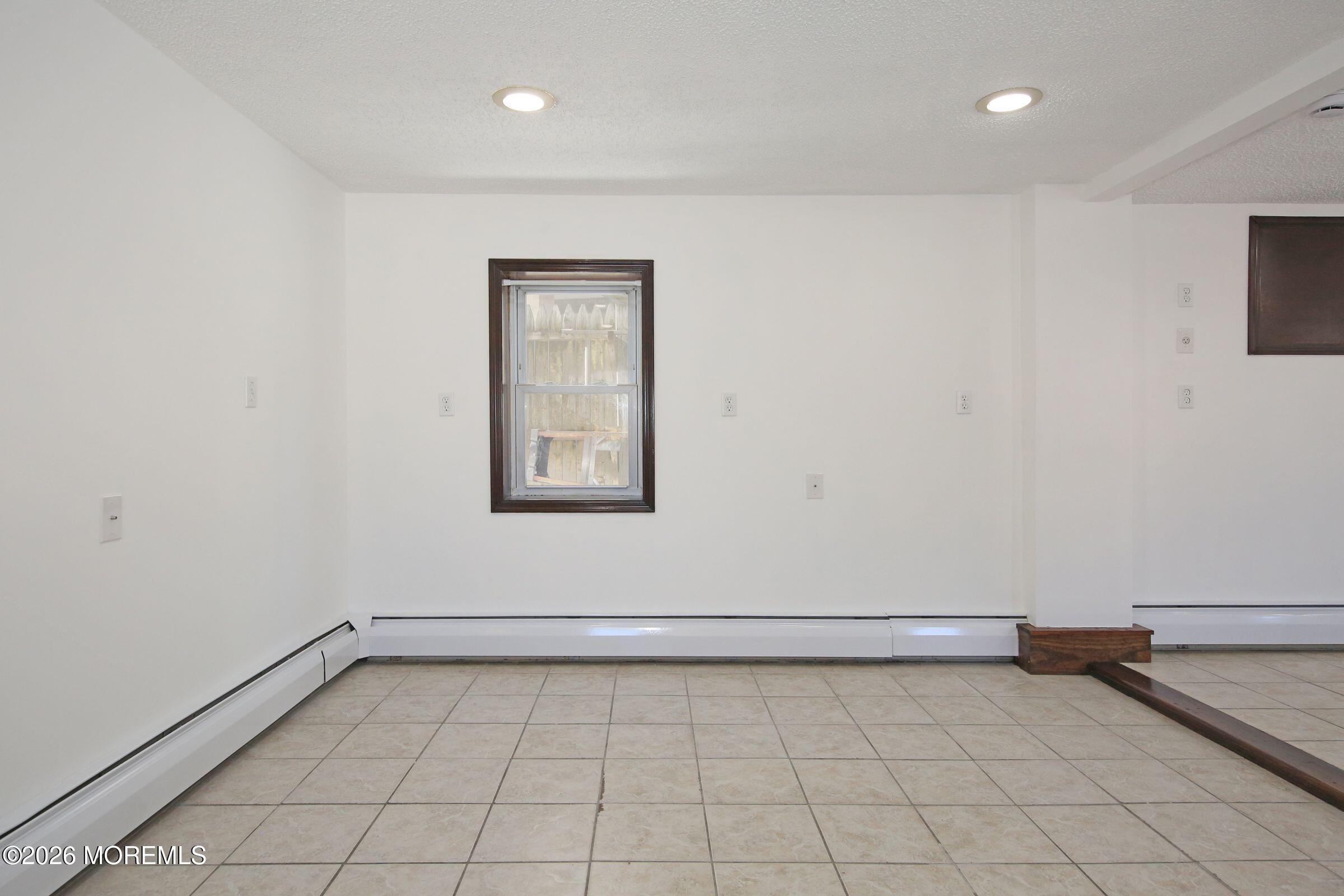 60 Matthew Street, Unit 1 Highlands, NJ 07732 - Photo 12 of 33 a view of a room with an empty space and a window