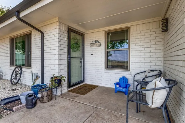 a living room with furniture a fireplace and a chandelier