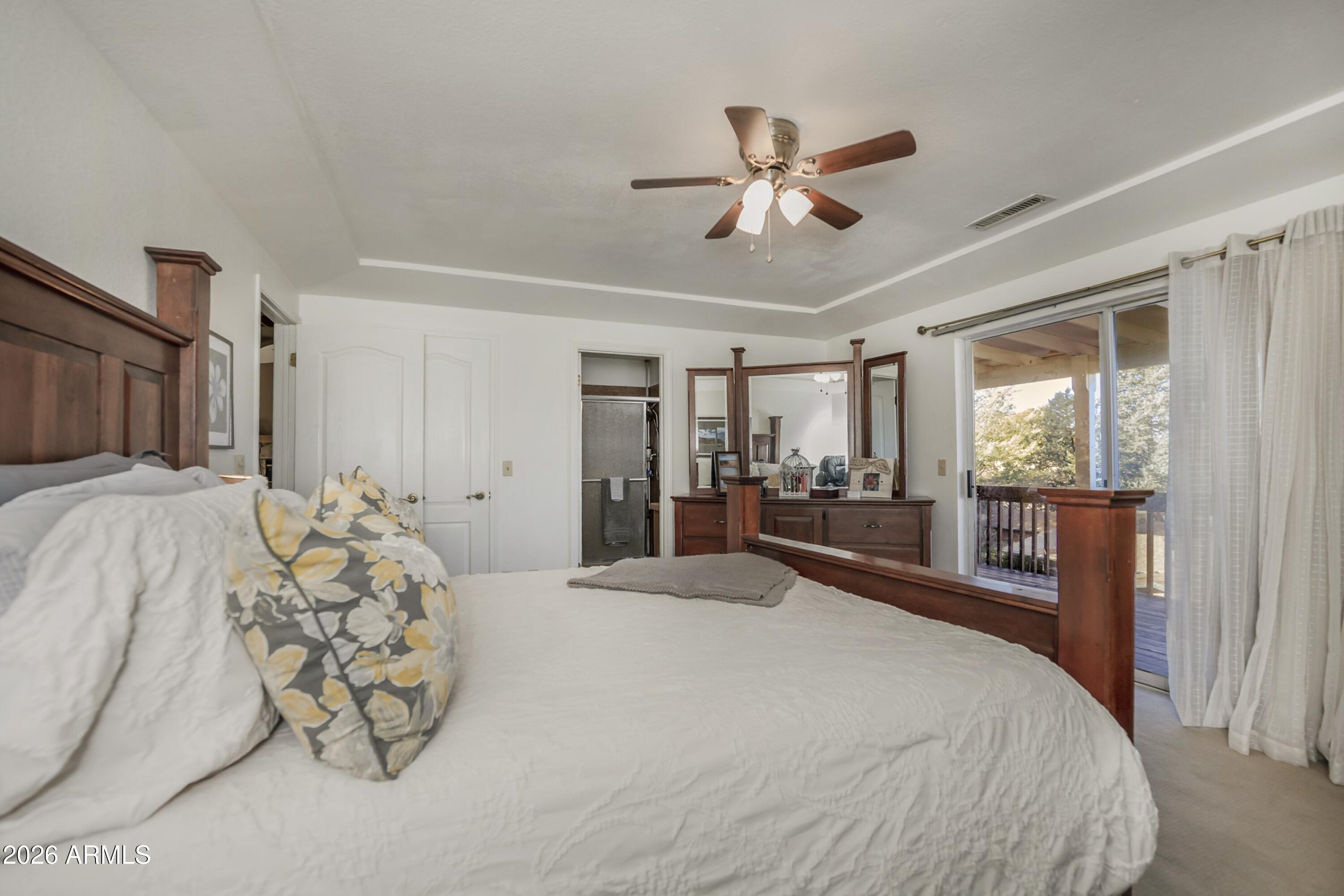 11160 Pima Road Dewey, AZ 86327 - Photo 13 of 58 a bedroom with a large bed and a window