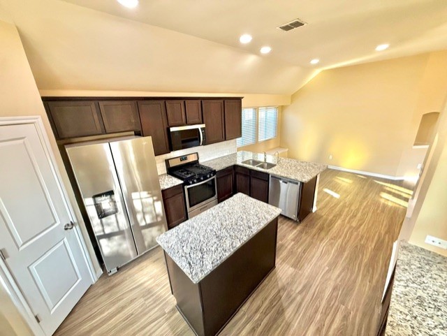 918 Silo Street San Marcos, TX 78666 - Photo 11 of 24 a open kitchen with stainless steel appliances granite countertop a sink stove and refrigerator