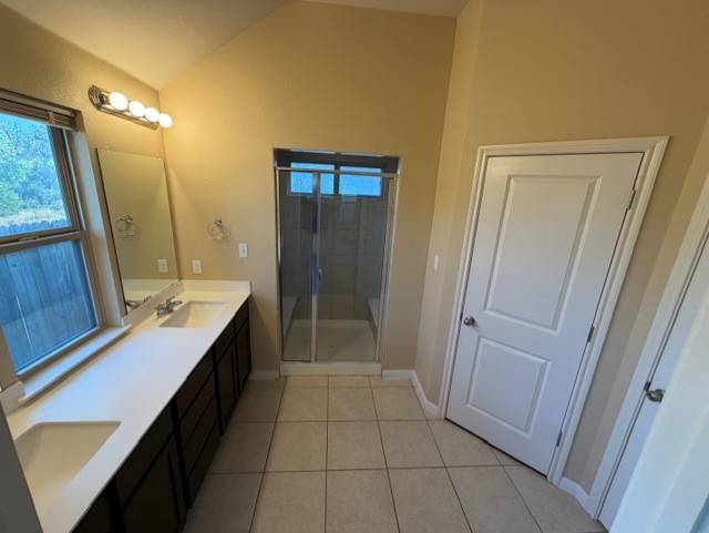 918 Silo Street San Marcos, TX 78666 - Photo 18 of 24 a bathroom with a sink a mirror and a shower