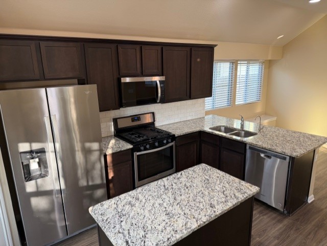 918 Silo Street San Marcos, TX 78666 - Photo 6 of 24 a kitchen with granite countertop a refrigerator stove and sink