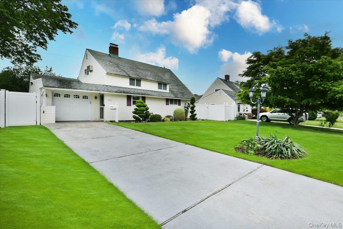 307 Blacksmith Road Levittown, NY 11756 - Photo 2 of 27 a front view of a house with a garden and yard