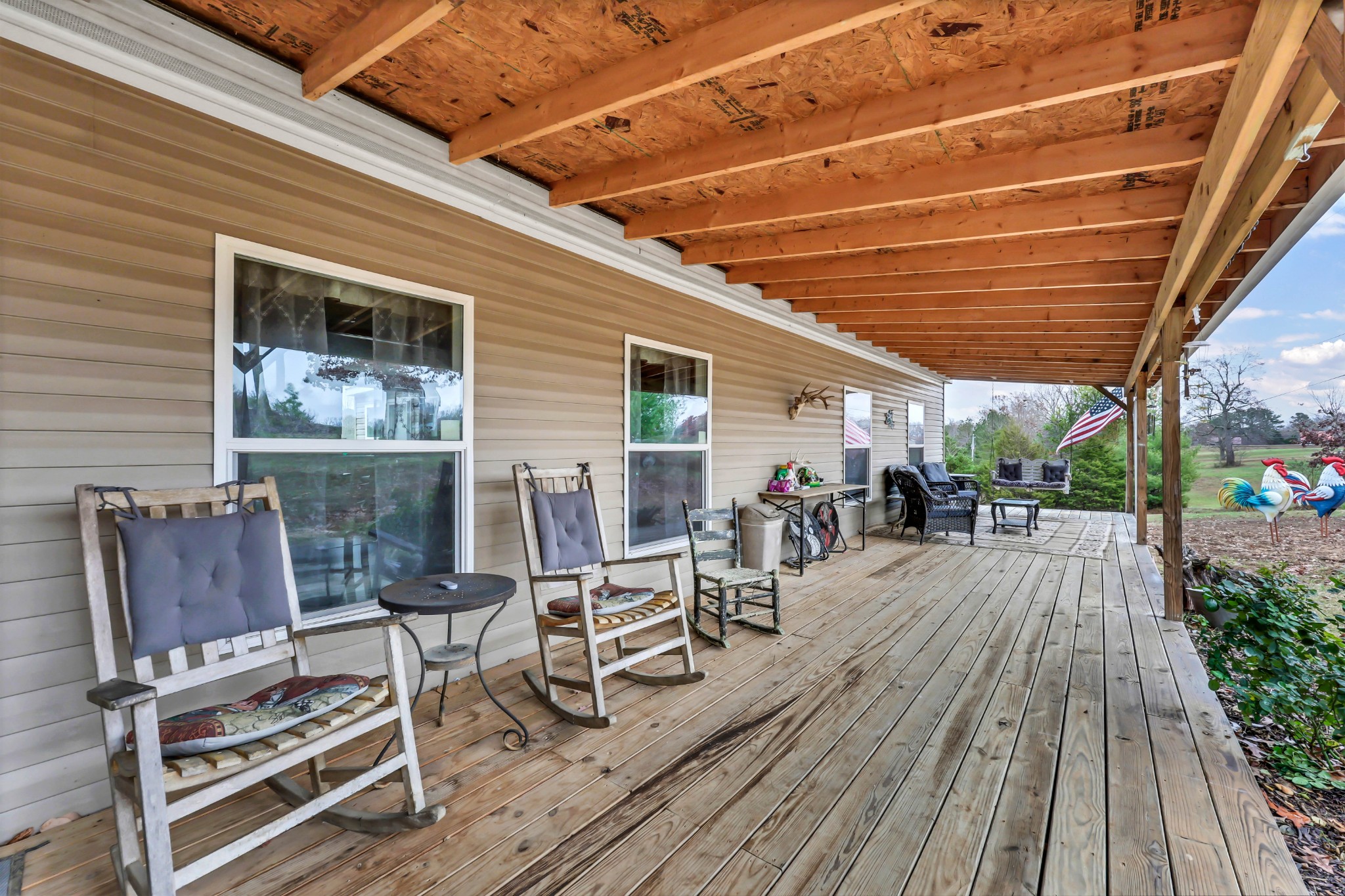 124 Old Lafayette Road Big Rock, TN 37023 - Photo 26 of 62 a view of a patio with table and chairs with wooden floor and fence