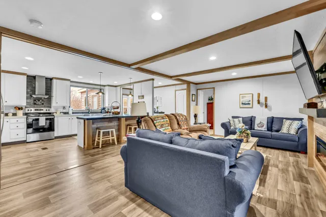 a spacious bedroom with a bed and a flat screen tv