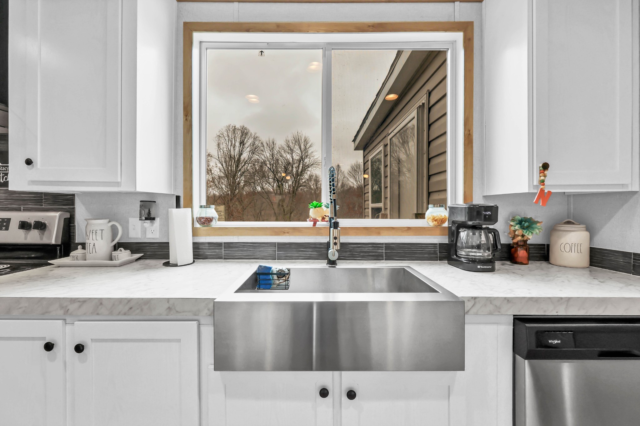 124 Old Lafayette Road Big Rock, TN 37023 - Photo 39 of 62 a kitchen with stainless steel appliances granite countertop a sink and a white cabinets