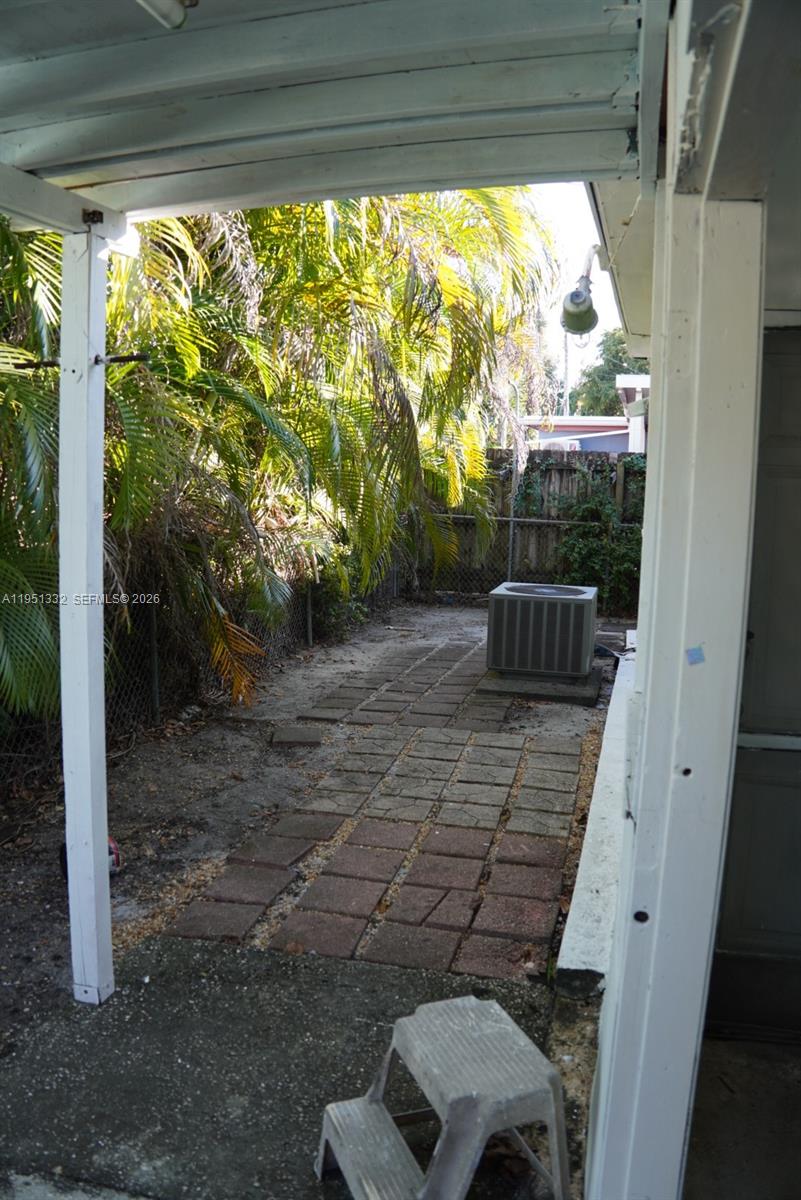 61 Southwest 58th Court, Unit D Miami, FL 33144 - Photo 7 of 7 a view of backyard with green space and porch