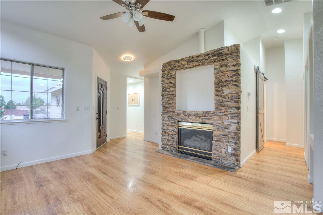 7553 Water View Way Reno, NV 89511 - Photo 6 of 31 a view of an empty room with a fireplace and a window