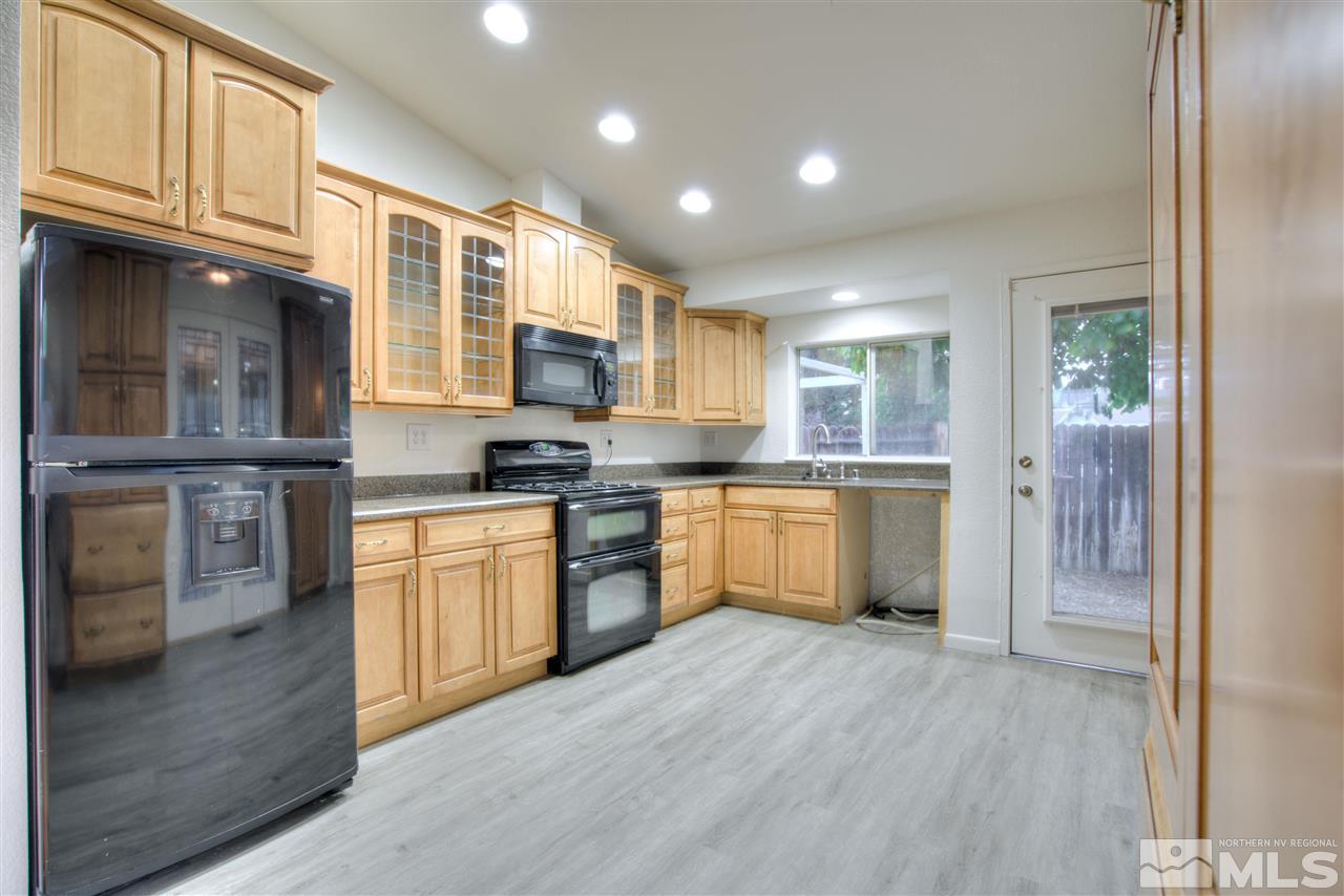 7553 Water View Way Reno, NV 89511 - Photo 9 of 31 a kitchen with stainless steel appliances granite countertop a stove a sink and a refrigerator
