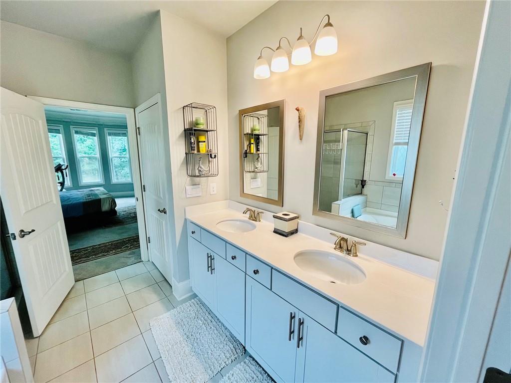 3015 Winding Ridge Waleska, GA 30183 - Photo 18 of 40 a spacious bathroom with a double vanity sink a mirror and a shower