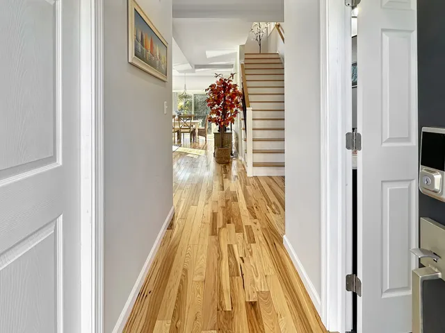 a view of entryway and hall with wooden floor